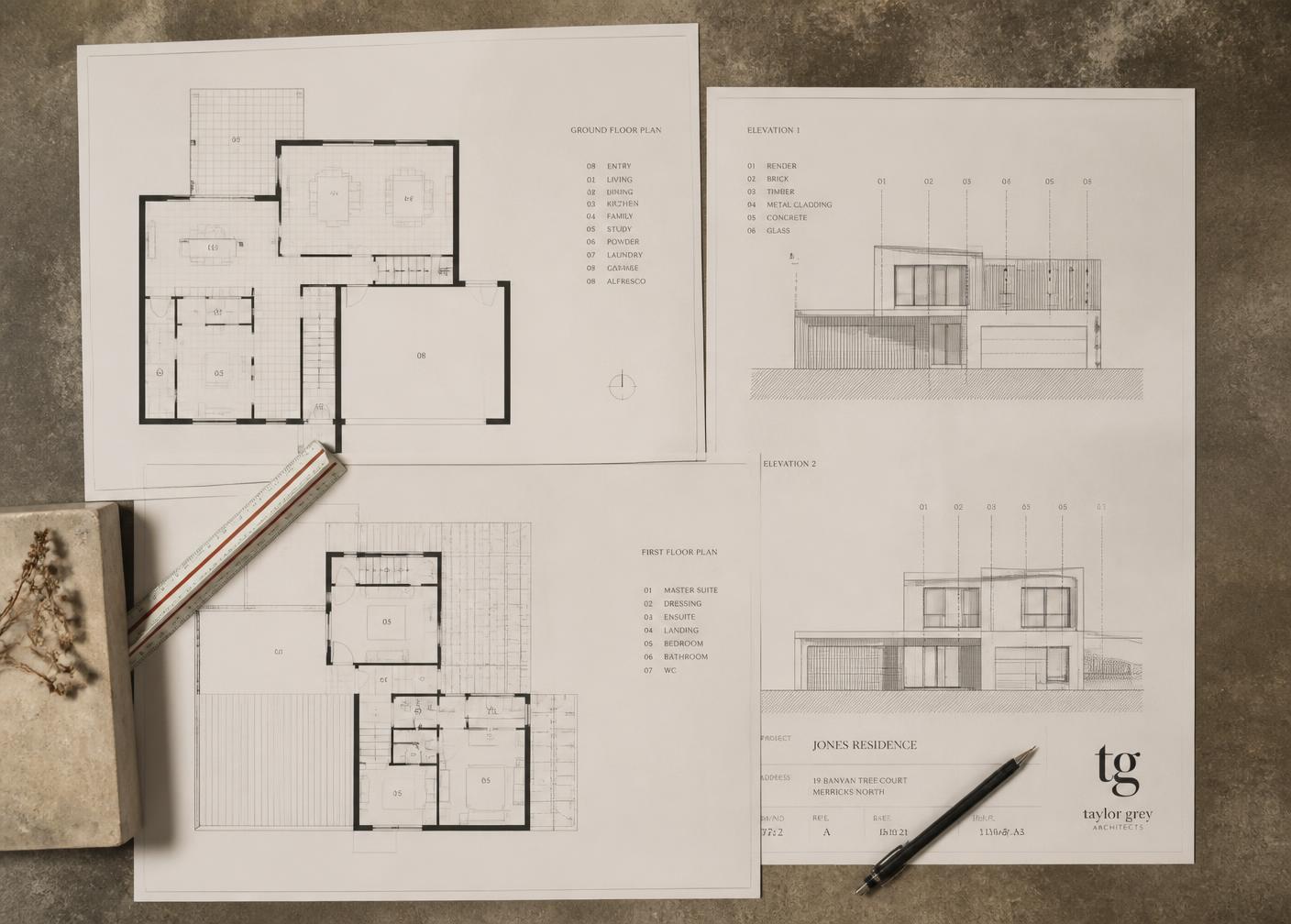 Architectural floor plans and elevation drawings on a work table